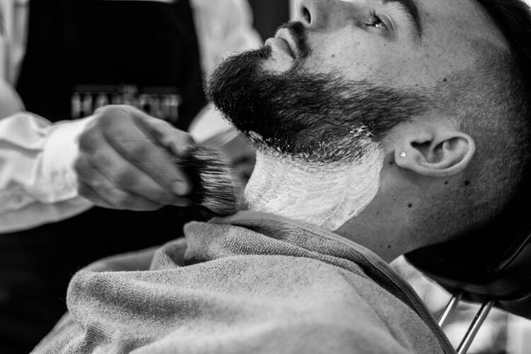 A man getting his hair cut at the barber