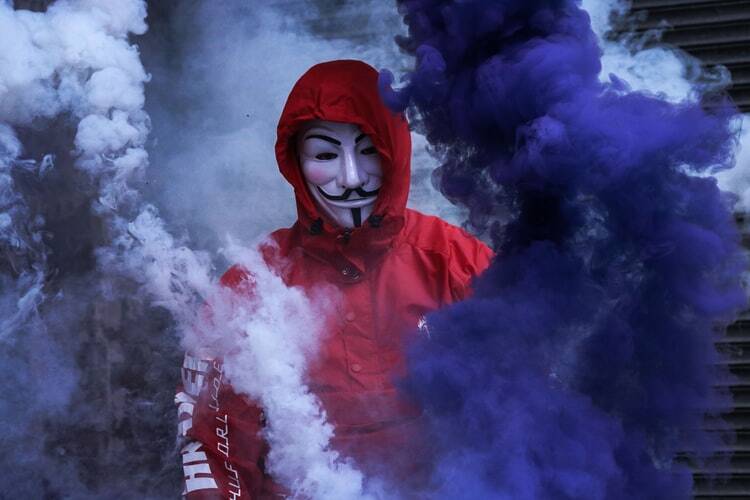 A man dressed in a white villain mask