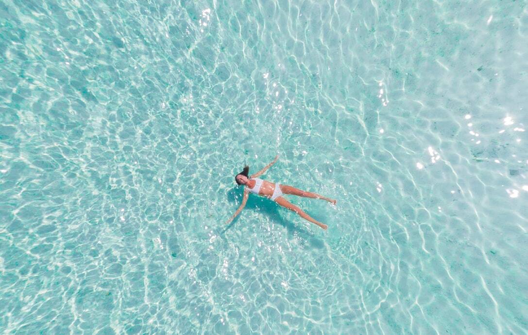 A woman relaxing on the surface of the water