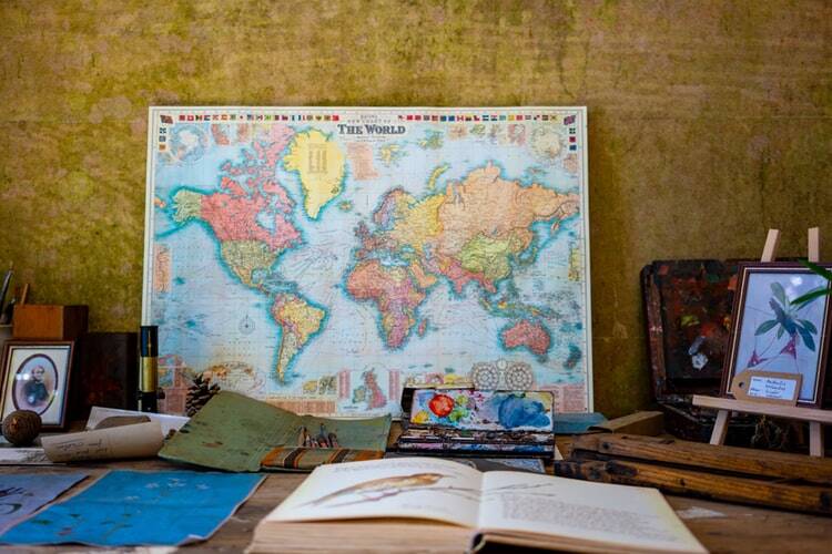 The desk of a foreign language student with a book, map, and pen