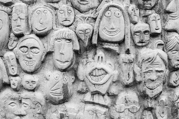 Many stone faces representing the many personalities of a linguist 