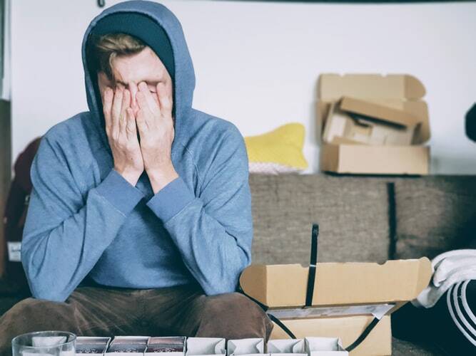 A man tired in the morning with his hands cover his face 