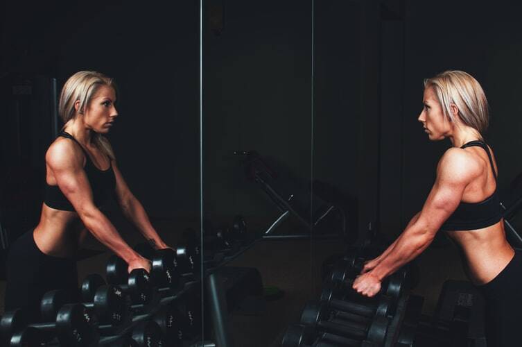 A woman working out her muscles in the gym