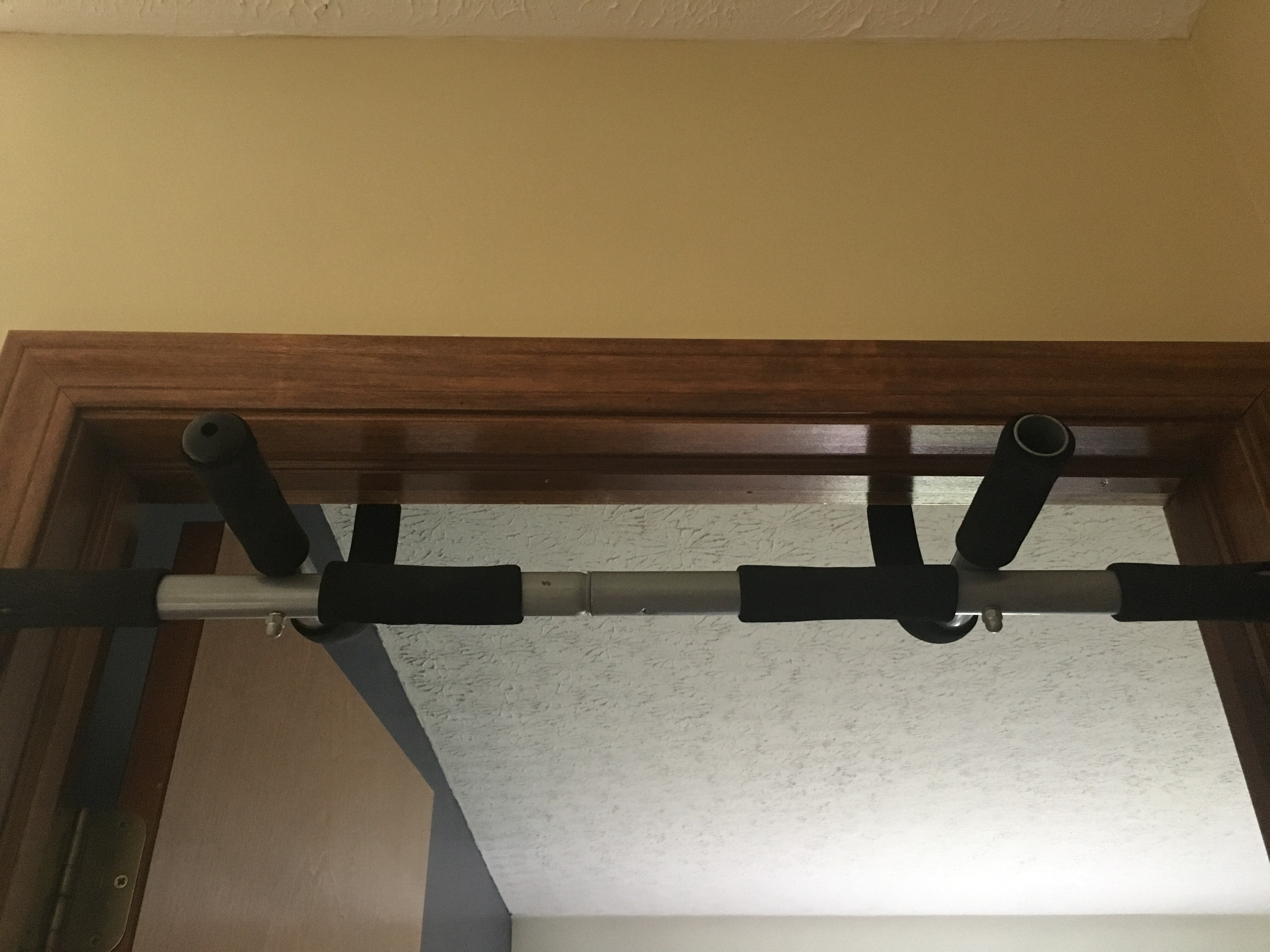 Iron gym workout bar in the pull-up position