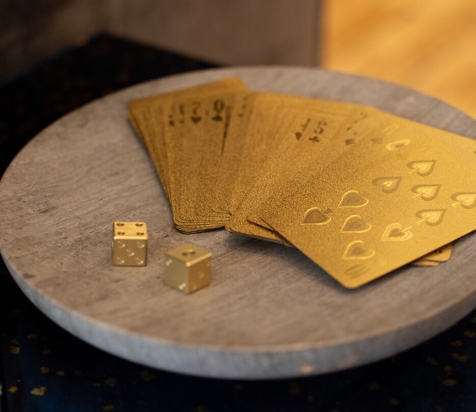 a deck of golden cards and die representing the magic of foreign languages