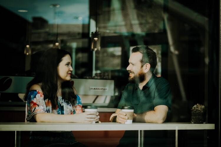 a couple talking in a foreign language over coffee