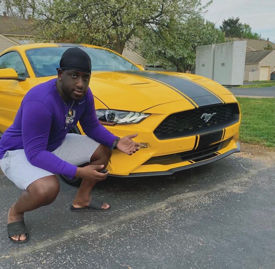 Ali with a yellow Ford Mustang